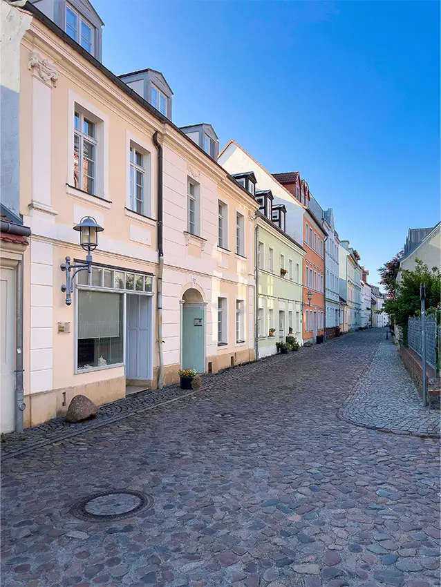 Kopfsteinpflasterstraße mit farbigen Häusern. Stadtteil Zentrum Fischerstrasse.