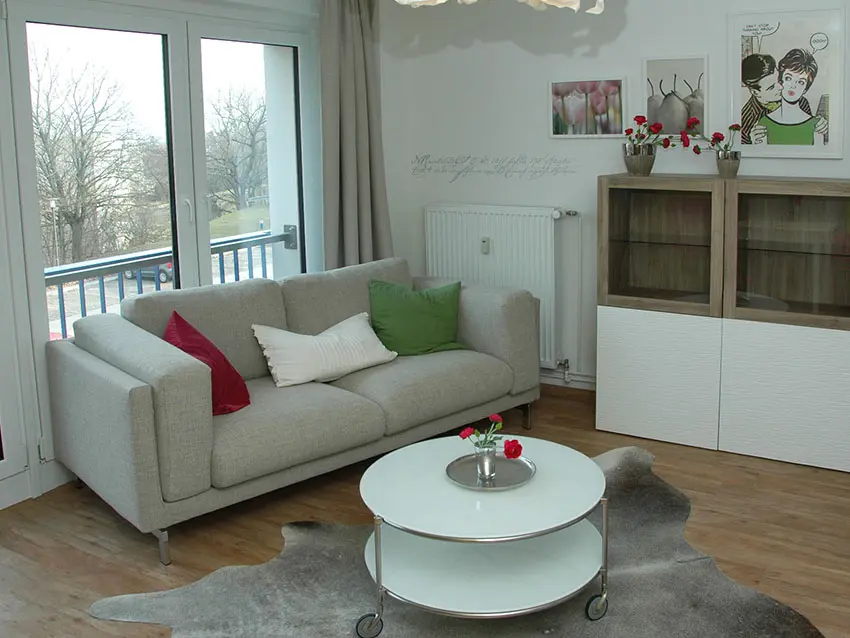 WOWI-FFO-Frankfurt-Oder-Moebliertes-Wohnen-14 Möbliertes Wohnen: Sofa mit Kissen, Couchtisch auf Teppich, Schrank, Fenster, Deko.