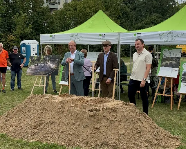 Spatenstich-Spielplatz-2 Feierlicher Spatenstich: Gruppe von Personen mit Spaten vor Erdhügel, Spielplatz im Kosmonauten-Viertel geplant.